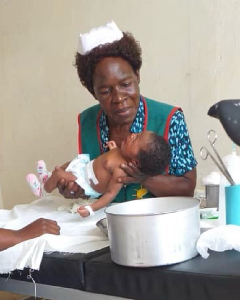 Nurse washing a newborn baby