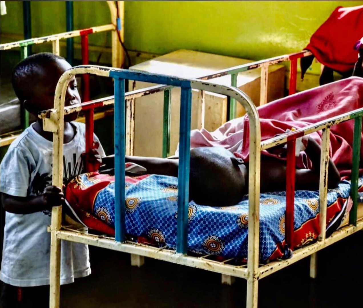 Children in a hospital bed in Uganda